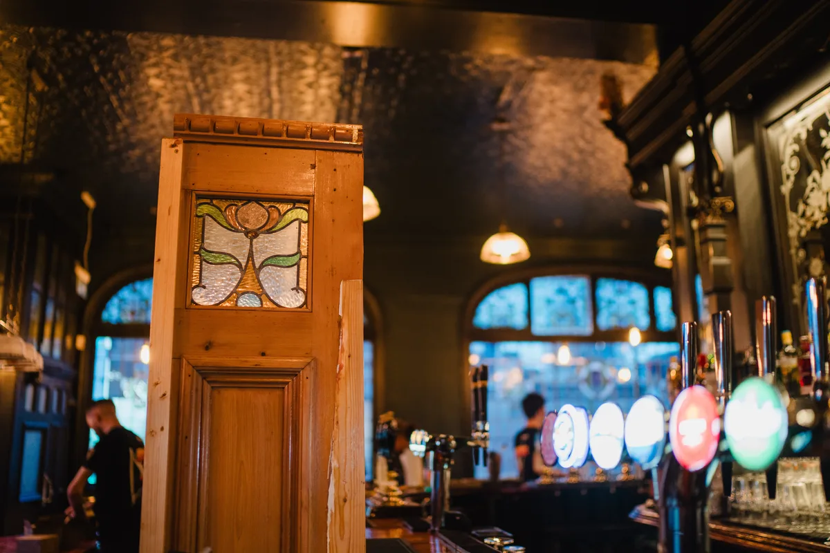 Edwardian timber and stained-glass partition screens inside The Anchor Digbeth