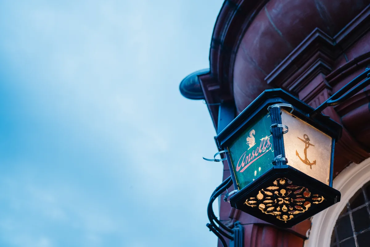 Historic Ansells Brewery exterior lantern mounted on the red brick facade of The Anchor Digbeth