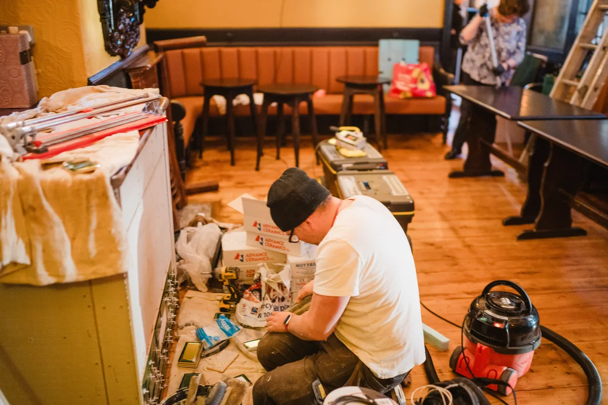 Craftsmen restoring historic ceramic tilework and joinery inside The Anchor Digbeth in 2025