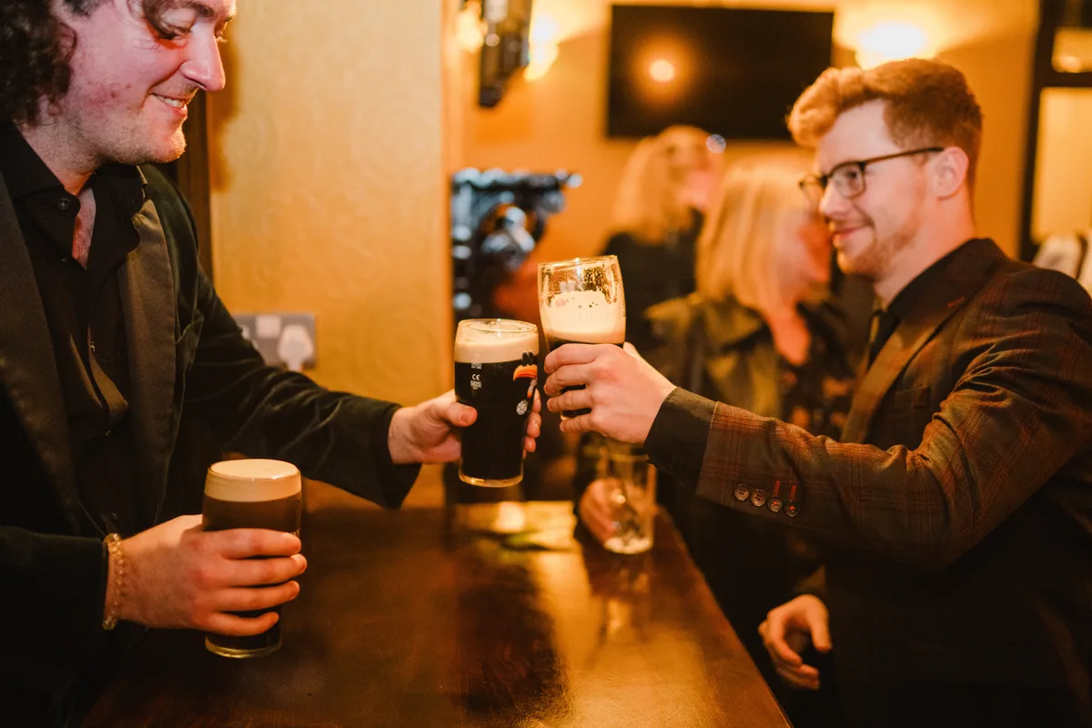 Regulars toasting with creamy pints of Guinness at The Anchor Digbeth relaunch